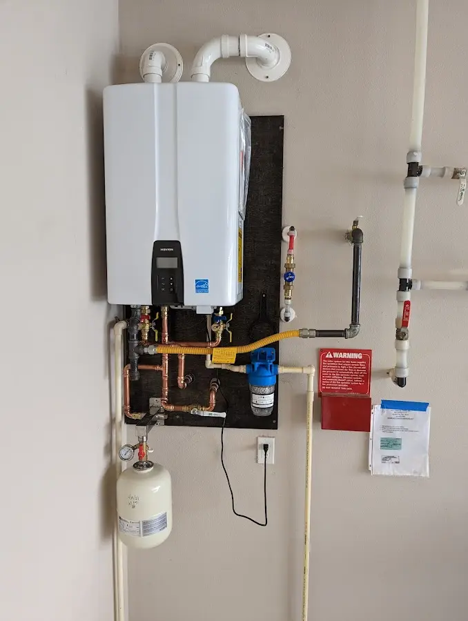 Professional plumber installing copper piping in a Chapel Hill home